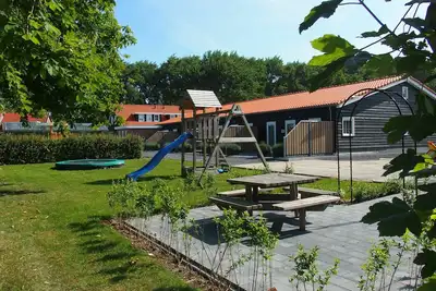 Modern, child-friendly, luxury holiday home in Oostkapelle, for six people, with a playground in front of the door