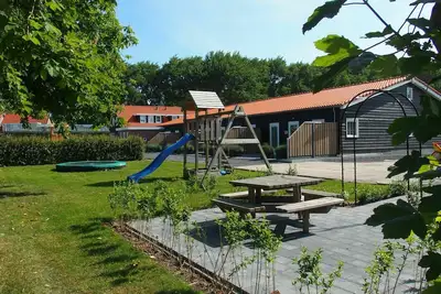 Child-friendly, modern holiday home in Oostkapelle with a collective playground