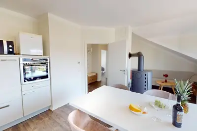 Bright, modern vacation apartment with fireplace and balcony near the beach