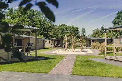 Image de A spacious bungalow with a nice veranda and a view of the playground