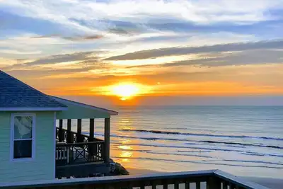 Image de Martinis & Bikinis, a beach front house with toes in the sand drink in the hand.