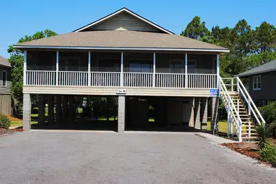 Second row beach home with screen porch and rockers at North Litchfield Beach in Pawleys Island.