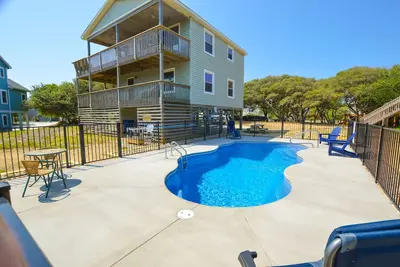 Image de Contemporary home with lots of decks and porches and surrounded by plenty of safe play area.