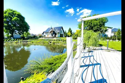 Image de This beautifull villa is located by the wather, surrounded by forest.