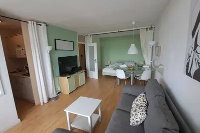 Image de Combined living and sleeping area with laminate flooring, comfortable couch and a
