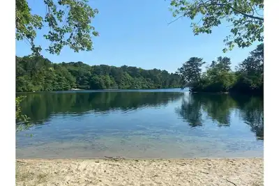Spacious home with private pond beach, steps from the rail trail