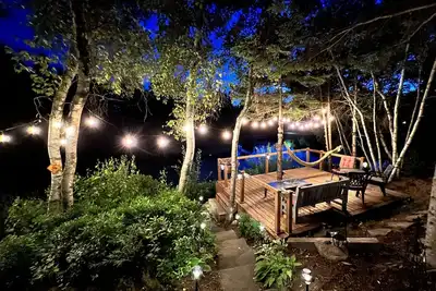 Image de Luxurious rustic wooden chalet on edge of tranquil pond in nature next to beach.