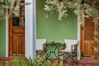 Cosy cottage with large veranda and garden with hammock near the beach.