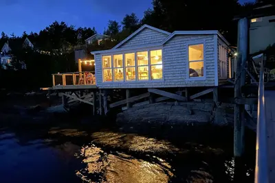 Image de Waterfront, west facing, modernized fisherman’s cottage perched on the water.