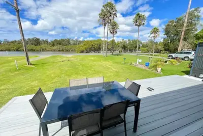 Image de Lakeside House Tuncurry with deck overlooking the lake