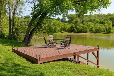 Image de Serene lake views featuring a private dock, sun deck + spacious fire pit