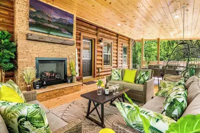 Image de Large covered patio with fireplace, outdoor dining area, new large hot tub