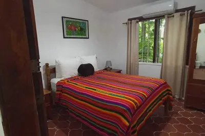 Image de Experience comfort and relaxation in our air-conditioned apartment, featuring two spacious bedrooms, a welcoming living room, a fully equipped private kitchen, and a well-appointed private bathroom. Perfect for families or groups.