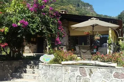 Image de Cozy country cottage with wooden ceilings and stone walls within nature reserve.