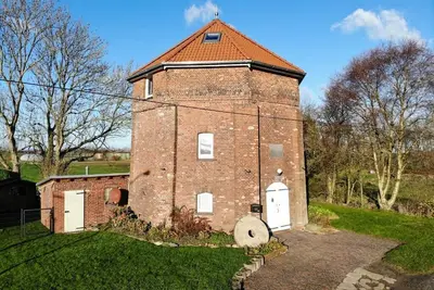 Image de 200 year old windmill as a vacation home near Greetsiel. Pet friendly!