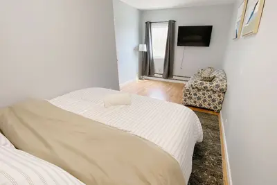 Cozy king suite with kitchen and dining area.