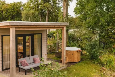 A lodge with hot tub and views over the Regge River. A sales pitch is really not necessary.