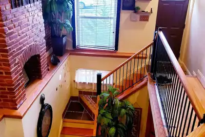 Exclusive Sunken Living Room Soaring Exposed Brick