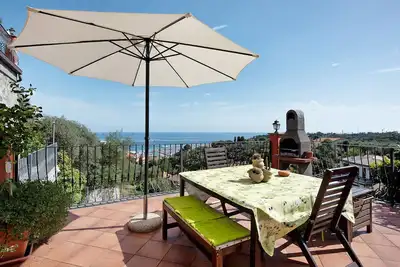 Image de Appartement de vacances \"Esclusiva Terrazza Vista Porto\" avec vue sur les montagnes et terrasse.