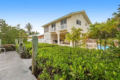 Waterfront hideaway with dock, pool & inviting patio - walk to Sombrero Beach