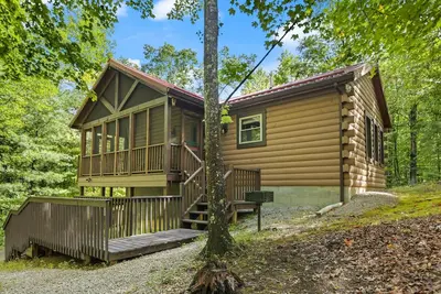 Image de Log Home with fenced in deck & screen porch, cosmopolitan style ranch design.