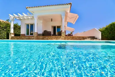 Sea view holiday home with garden and private pool on the sandy beach in Roche