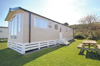 Image de Stylish 12ft-wide caravan with one double and two twin.