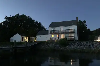Spacious waterfront home with dock and sunset view