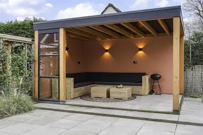 Image de Stylish vacation home with bright furnishings and garden and terrace and porch.