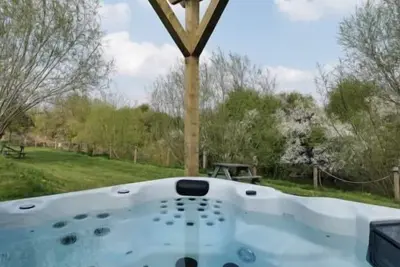 Large three bedroom log cabin with private hot tub and decking over looking the beautiful river Brue