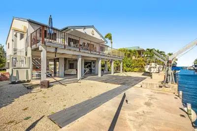 Renovated waterfront duplex w/canal access, pool, patio, deck, & central Ac