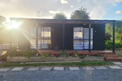 Image de Whare Koa awaits to provide that relaxing ambience for you with all day sun! !