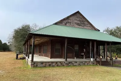 Image de Country estate log cabin, elevated wrap around porch. Live Oak, Cypress and Pine