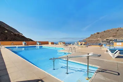 Image de Appartement de vacances 'ParaĂso Taurito' avec vue sur la mer, terrasse, piscine partagĂ©e et Wi-Fi