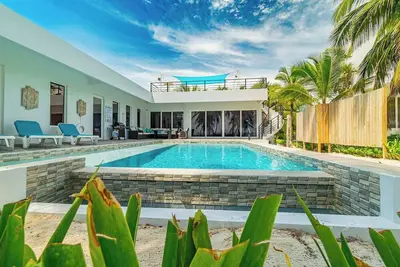 Escape to this stunning 3-bedroom villa nestled on the white sands of northern Ambergris Caye.