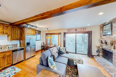 Inviting riverfront home with balcony, fireplace, skiing, W/D & dog-friendly