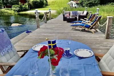 Log house with private beach and own dock incl. boat