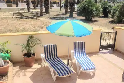 Image de First floor apartment with palm garden and pool near the beach