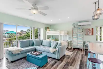 Canal-front home with boat access, deck, grill, & washer\/dryer