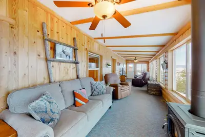 Inviting lake view home with fireplace, golf nearby, full kitchen, & W/D