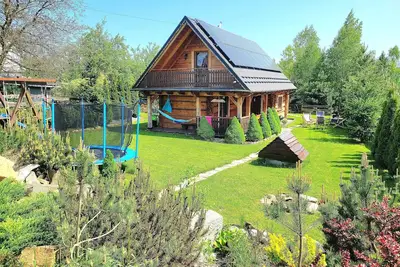 Image de A beautiful wooden house with a sauna and jacuzzi and a large garden.