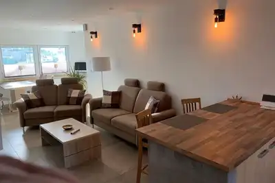 Image de First floor vacation apartment on approx. 78 sqm, high-quality and modern furnishings with furnished terrace with garden pond and barbecue facilities, covered e-bike charging station and lockable bicycle room. You can look forward to: a fully equipped. .