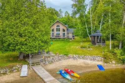 Image de This well equipped lake house has a private beach and all-day sun.