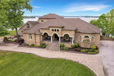 Image de Stunning waterfront villa with indoor pool and kids swing set and play area.