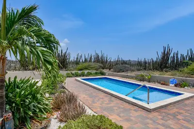 Image de Welcome to our vacation villa in Noord, an oasis of relaxation nestled in nature.