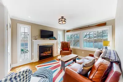 Image de Waterfront home with private beach & dock, water views, deck, & fireplace