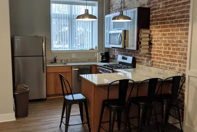 Modern 2-bedroom apartment with cozy fireplace, walkable village location!