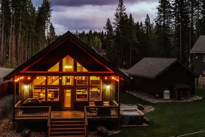 Image de 3 Br 2 Ba home  w/ hot tub, game room, forest views, hot tub, and fire pit.