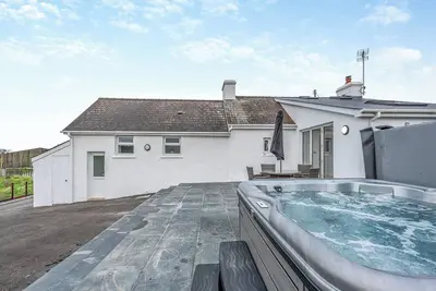 Image de Boasting your very own hot tub, with views across the meadows, and less than 3 miles to the beach.