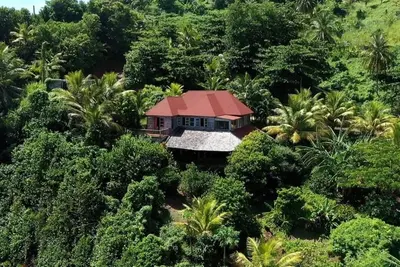 Private wooden villa with stunning ocean views, in an enchanting garden setting.
